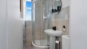 Shower, hair dryer, towels, shampoo