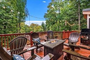 A deck with Adirondack chairs, a fire pit, and a grill. - Sleeps 15!|Indoor Fireplace|HotTub|Pets OK|Game RM (Beech Mountain)