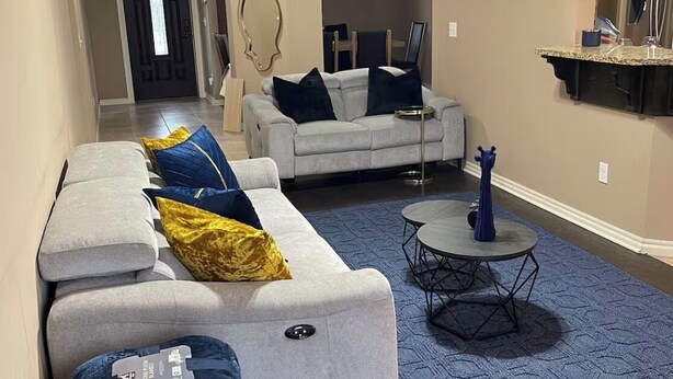 A modern living room with a sofa, a coffee table, and a rug. - Central Urban Glam Getaway near Moore, OKC, Norman (Oklahoma City)