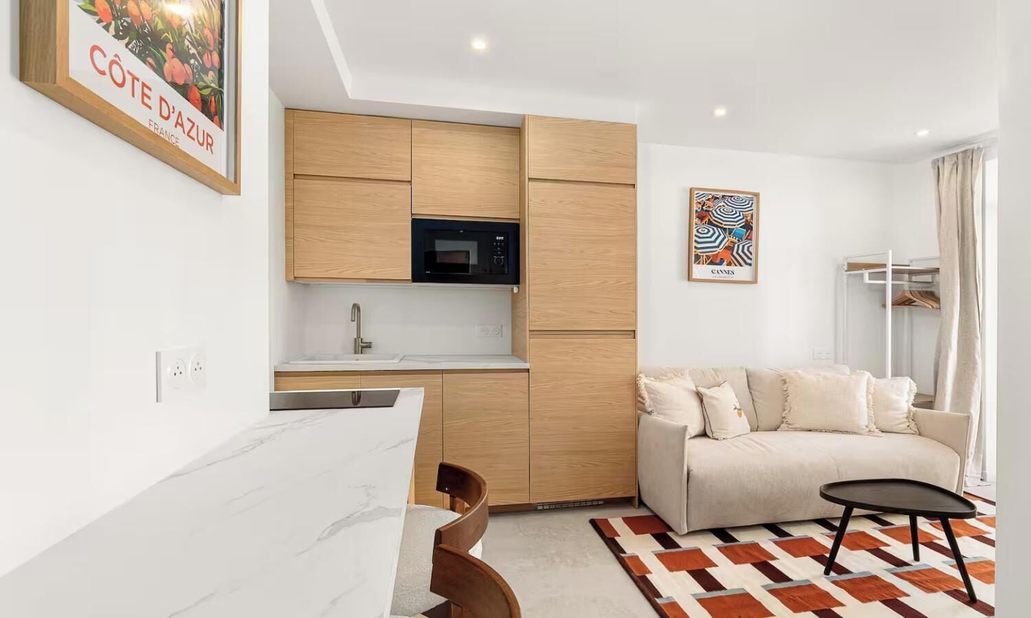 A modern apartment with a kitchen, a dining area, and a living room.