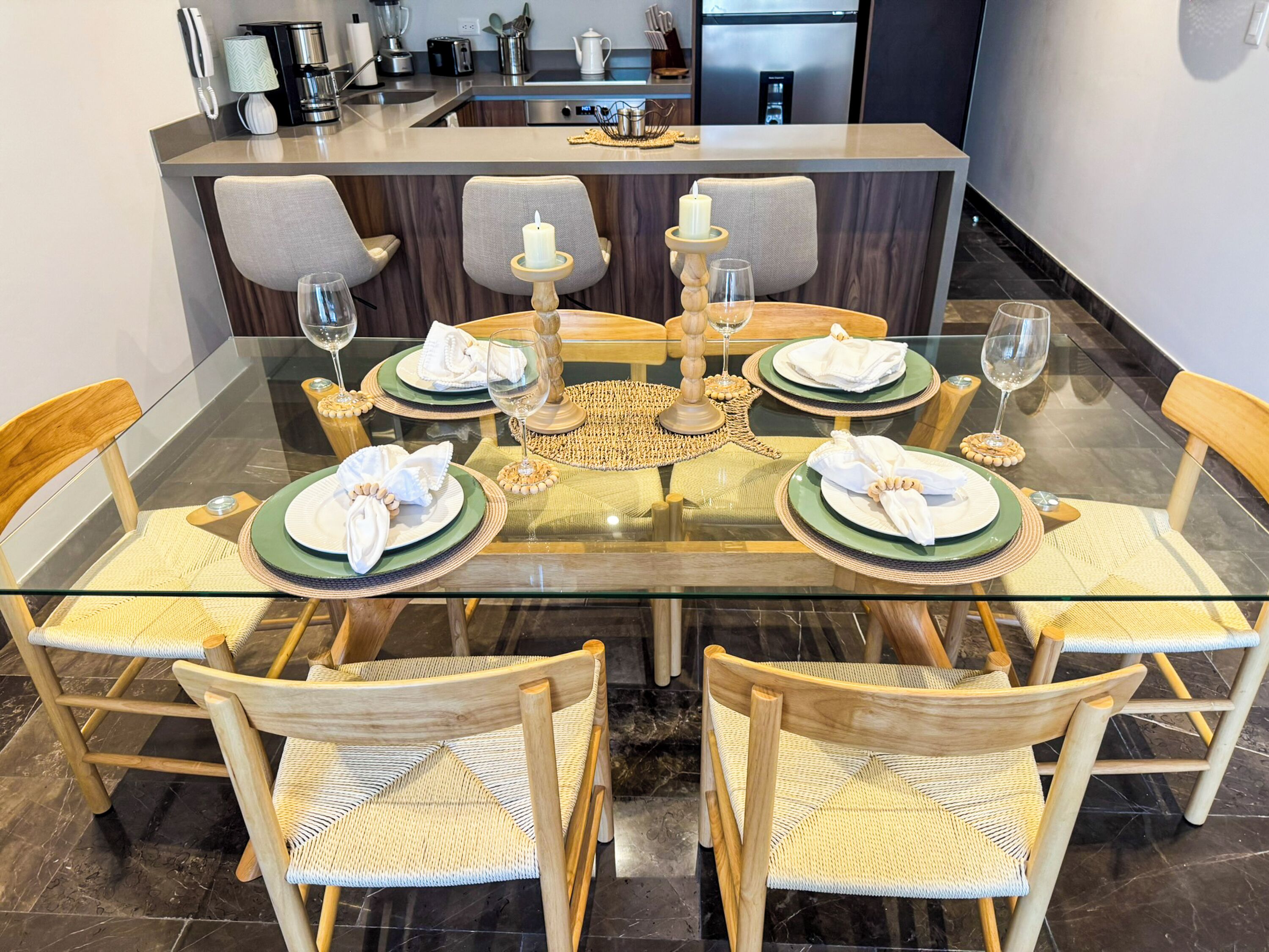 A modern kitchen with a dining area set for four.