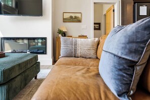 A living room with a sofa, a television, and a framed picture on the wall. - !New!-Sunset Escape- Bayside Bluff with Hot Tub (Egg Harbor)