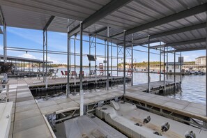A covered marina with multiple docks, seating areas, and a clear view of the water. - Osage Beach, 4b, Private cove, sleeps 10 (Osage Beach)
