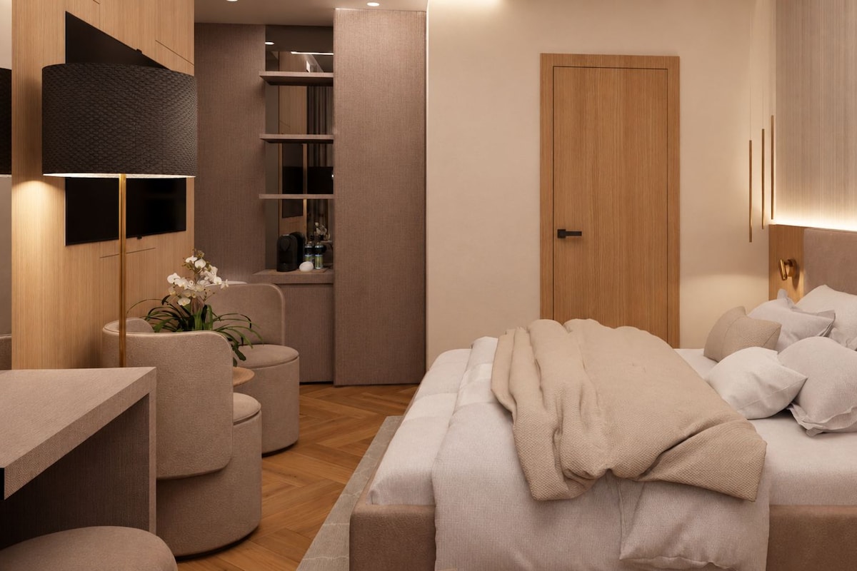A modern bedroom with a bed, bedside tables, a desk, and a chair.