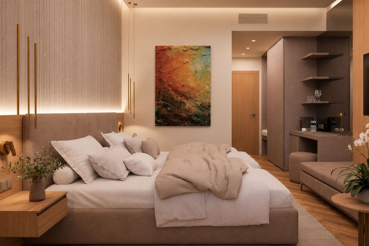 A modern bedroom with a large bed, bedside tables, a TV, and a painting on the wall.