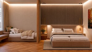 Ein modernes Schlafzimmer mit einer Schlafcouch, einem Bett und einem Nachttisch.