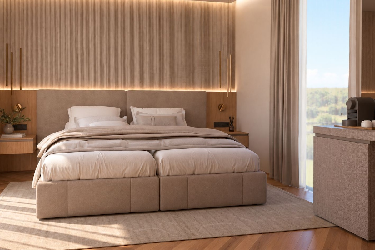A modern bedroom with a large bed, bedside tables, and a view of the outdoors.
