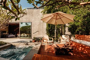 An outdoor pool area with a wooden deck, lounge chairs, and a large umbrella. - Luxury 3BR Ocean View Home with Pool -  Featured in The New York Times! (Los Angeles)