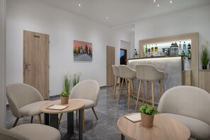 A hotel lobby with a bar area, seating, and a painting on the wall. - Prague Season Hotel (Prague)