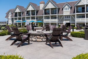 A multi-story hotel with outdoor seating areas, a fire pit, and a pool. - Carlsbad Inn Beach Resort Hotel (Carlsbad)