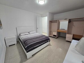 A bedroom with a bed, a wardrobe, a desk, and a mirror. - "Family Christmas with a Private Pool" Brings Guests to Juana Díaz, Puerto Rico (Rio Canas Abajo Juana Díaz)