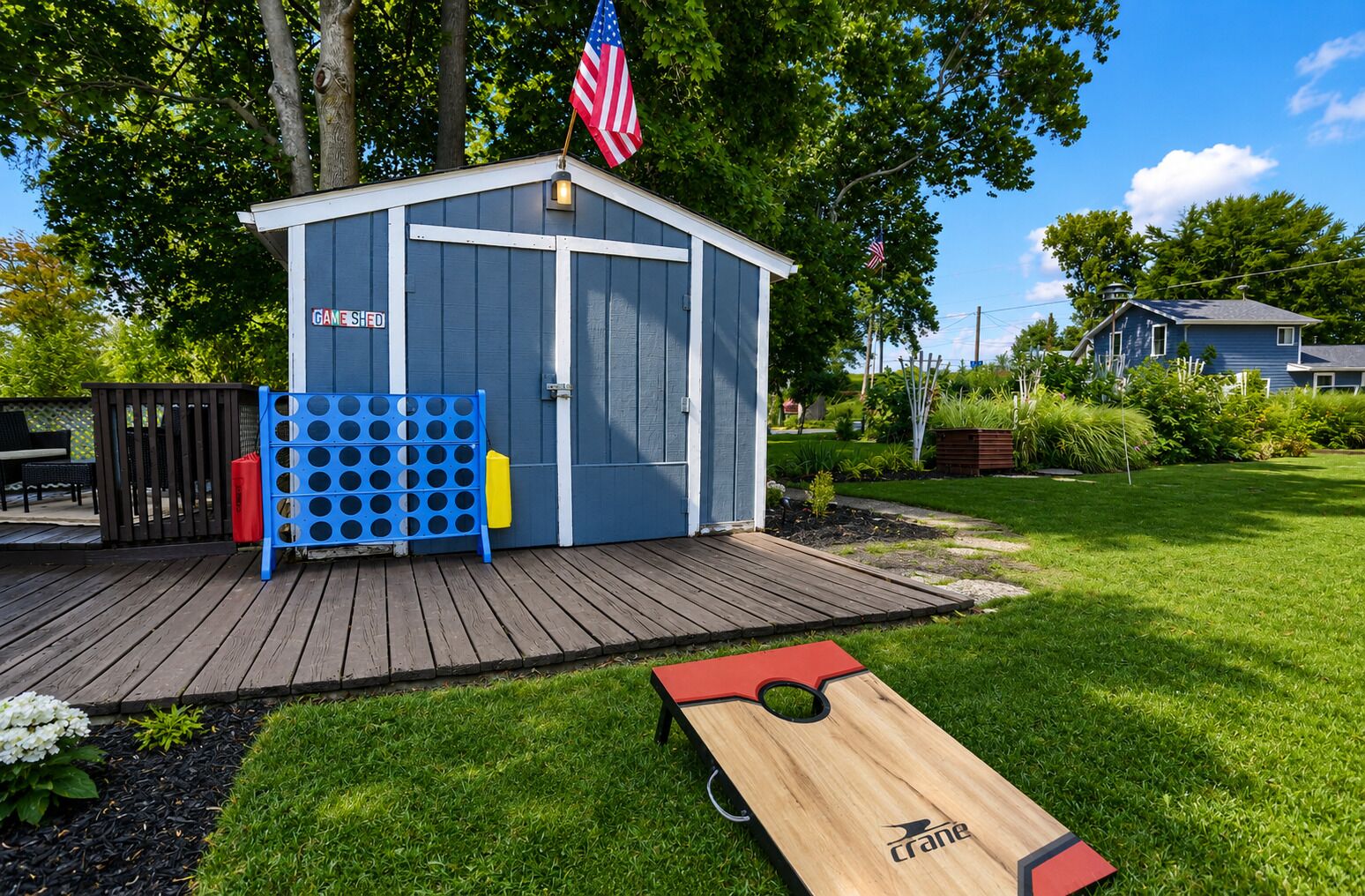 A wooden deck with a shed labeled 'GAME SHED' and a disc golf tee.