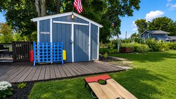 A wooden deck with a shed labeled 'GAME SHED' and a disc golf tee.