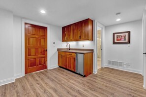 A kitchen with wooden cabinets, a stainless steel refrigerator, and a sink. - North Boulder Elegance - Newlands Neighborhood (Boulder)