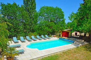 A swimming pool with lounge chairs and a small building with red shutters. - A beautiful, restored farmhouse in a quiet setting, with an enclosed garden for dogs and a stunning view. (Viviers)
