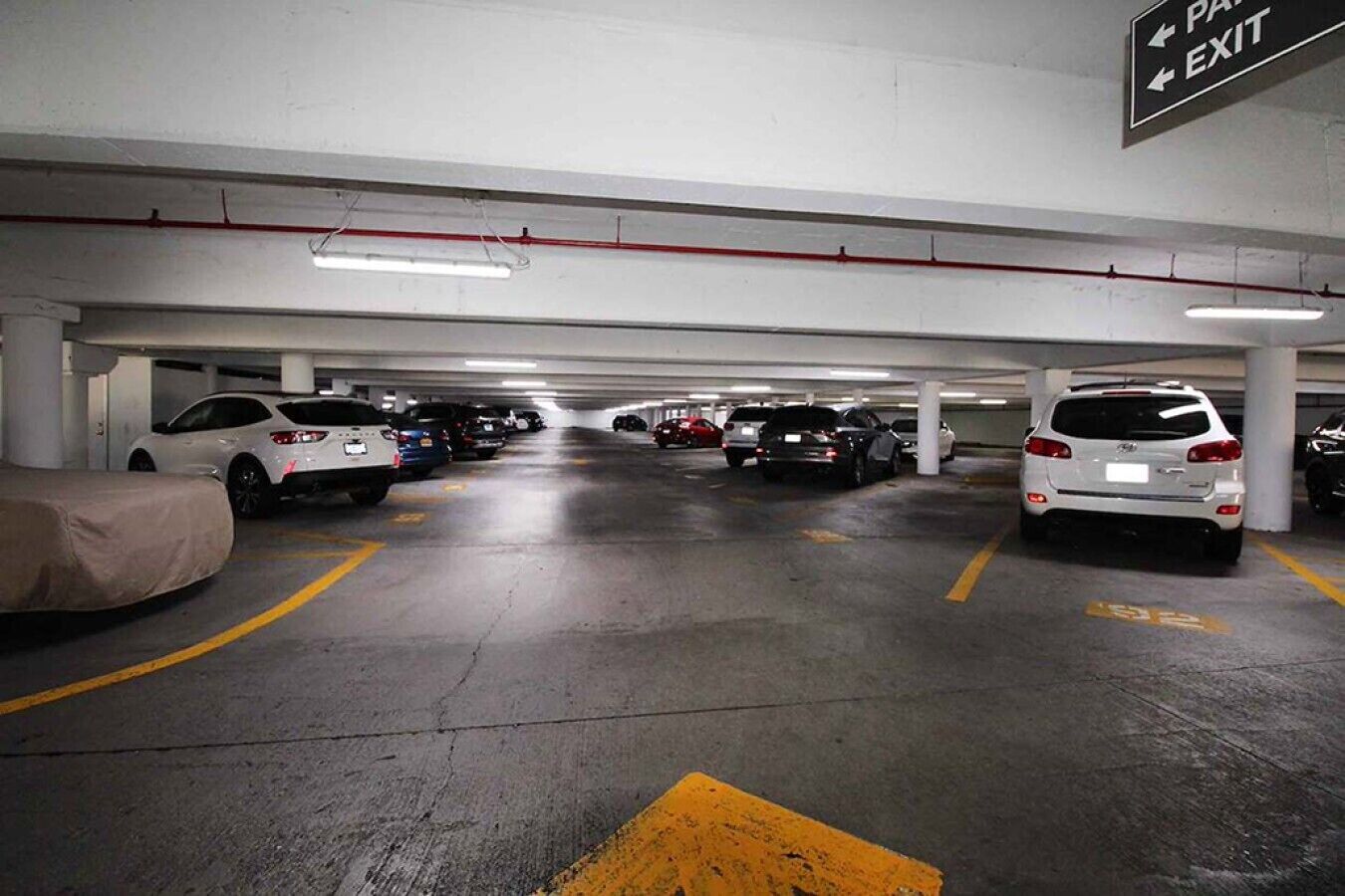 A multi-level parking garage with cars parked in designated spaces.