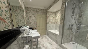 A bathroom with a marble floor, a shower, a sink, and a toilet. - The Secret Garden (Kinsale)