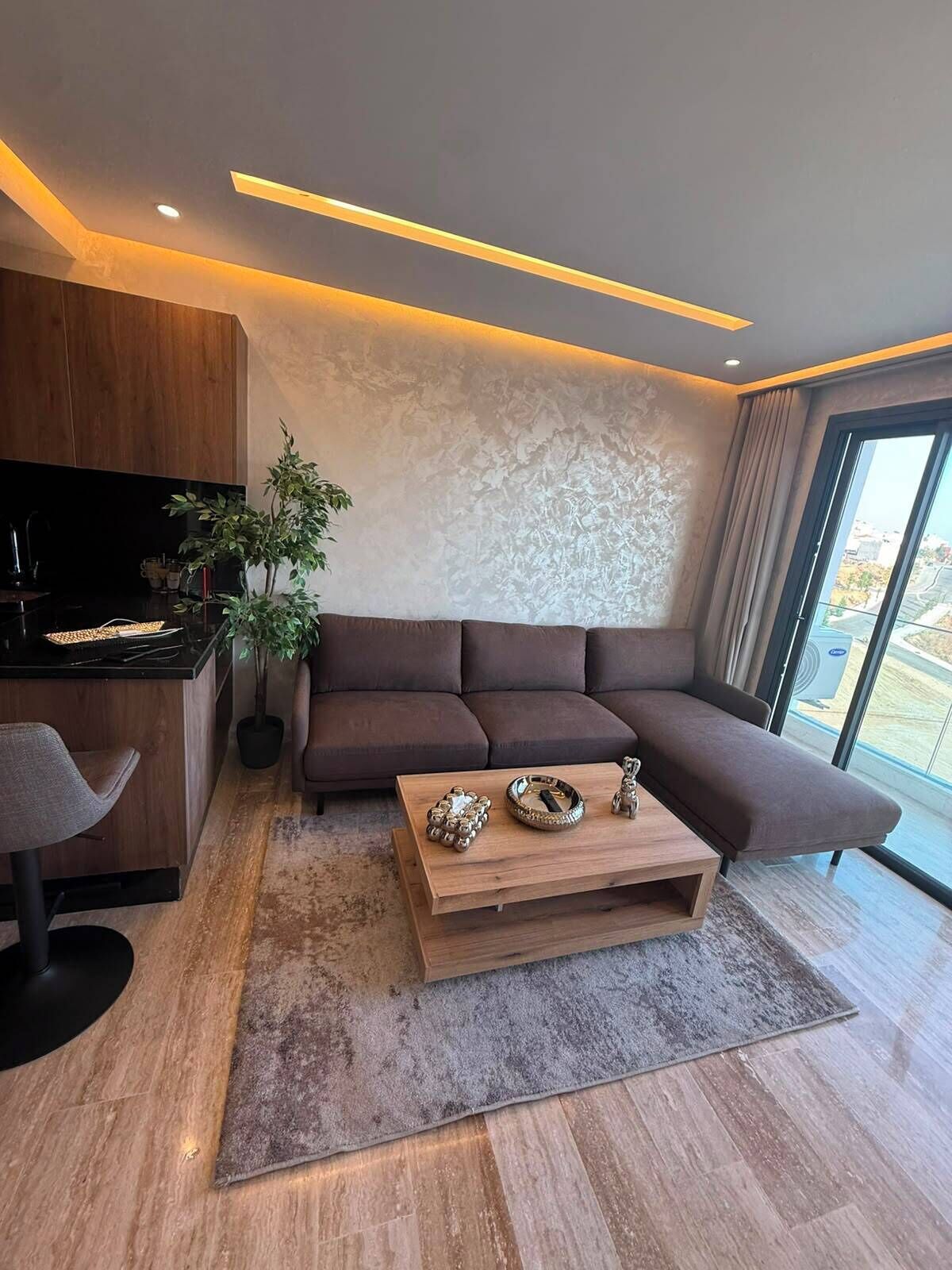 A modern living room with a sofa, a coffee table, and a TV.
