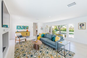 Ein modernes Wohnzimmer mit Sofa, Couchtisch und Bildern an den Wänden.
