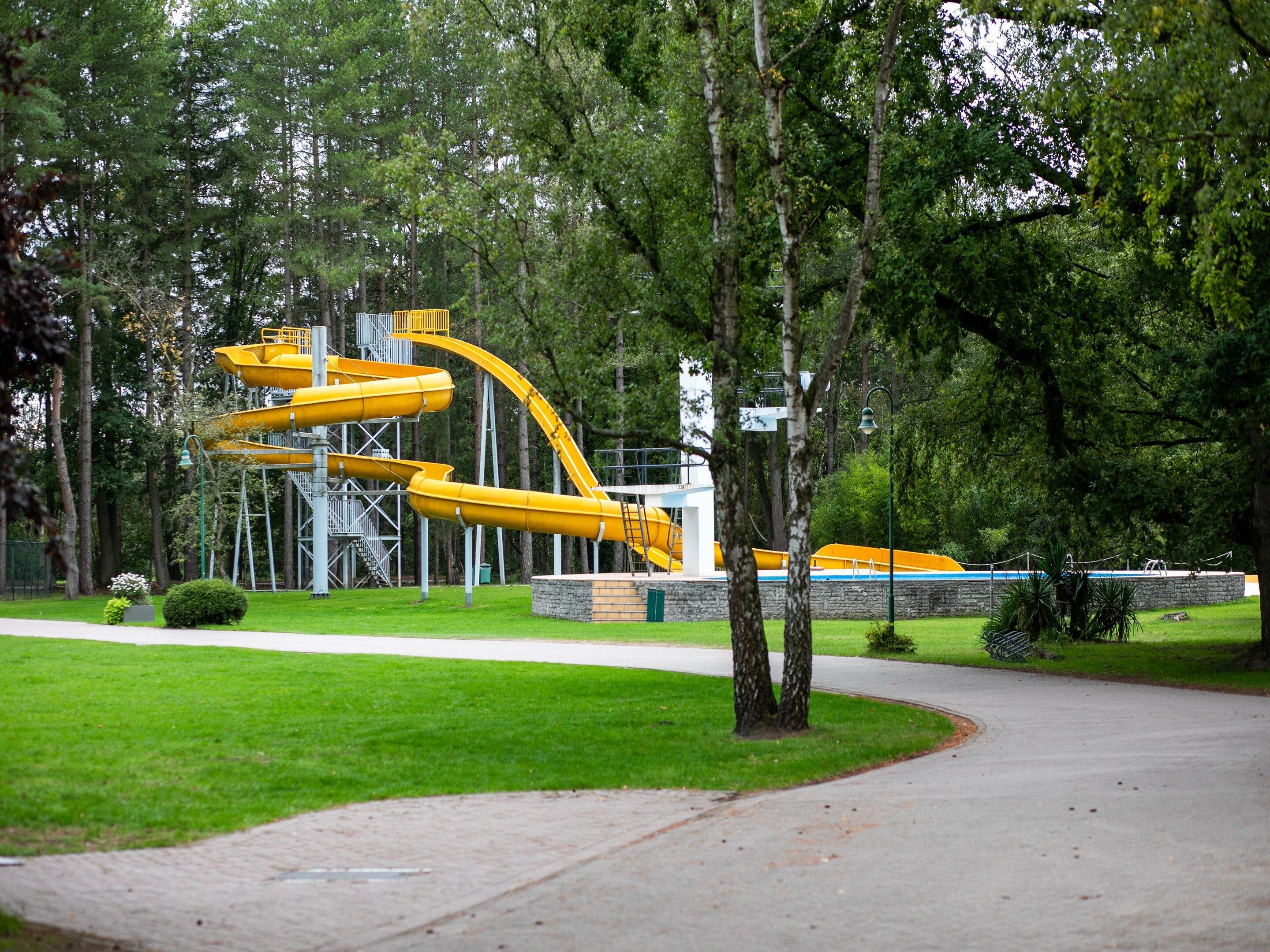 A water park with multiple slides and a pool area.