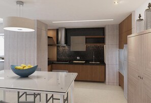 A modern kitchen with a glass-top table, a bowl of lemons, and a black speckled backsplash. - SPECTACULAR 3 BR SUITE WITH PLUNGE POOL IN 5 DIAMOND RESORT NUEVO VALLARTA JD (las jarretaderas)