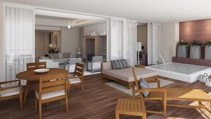 Ein moderner Wohnbereich mit Esstisch, Sofas und einer kleinen Küche im Hintergrund.