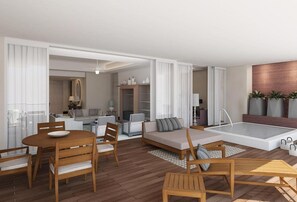 A modern living area with a dining table, sofas, and a small kitchen in the background. - SPECTACULAR 3 BR SUITE WITH PLUNGE POOL IN 5 DIAMOND RESORT NUEVO VALLARTA JD (las jarretaderas)