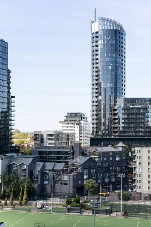 A high-rise building with a modern design, surrounded by other residential buildings. - Urban Calm Comfortable Base with City Views and Gym (South Yarra)