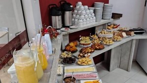 A buffet table with various food items and beverages.