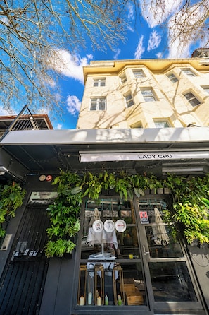 A building with a sign reading 'LADY CHU' and a storefront with a glass facade. - Roslyn Studio Between Harbour Calm and City Energy (Potts Point)
