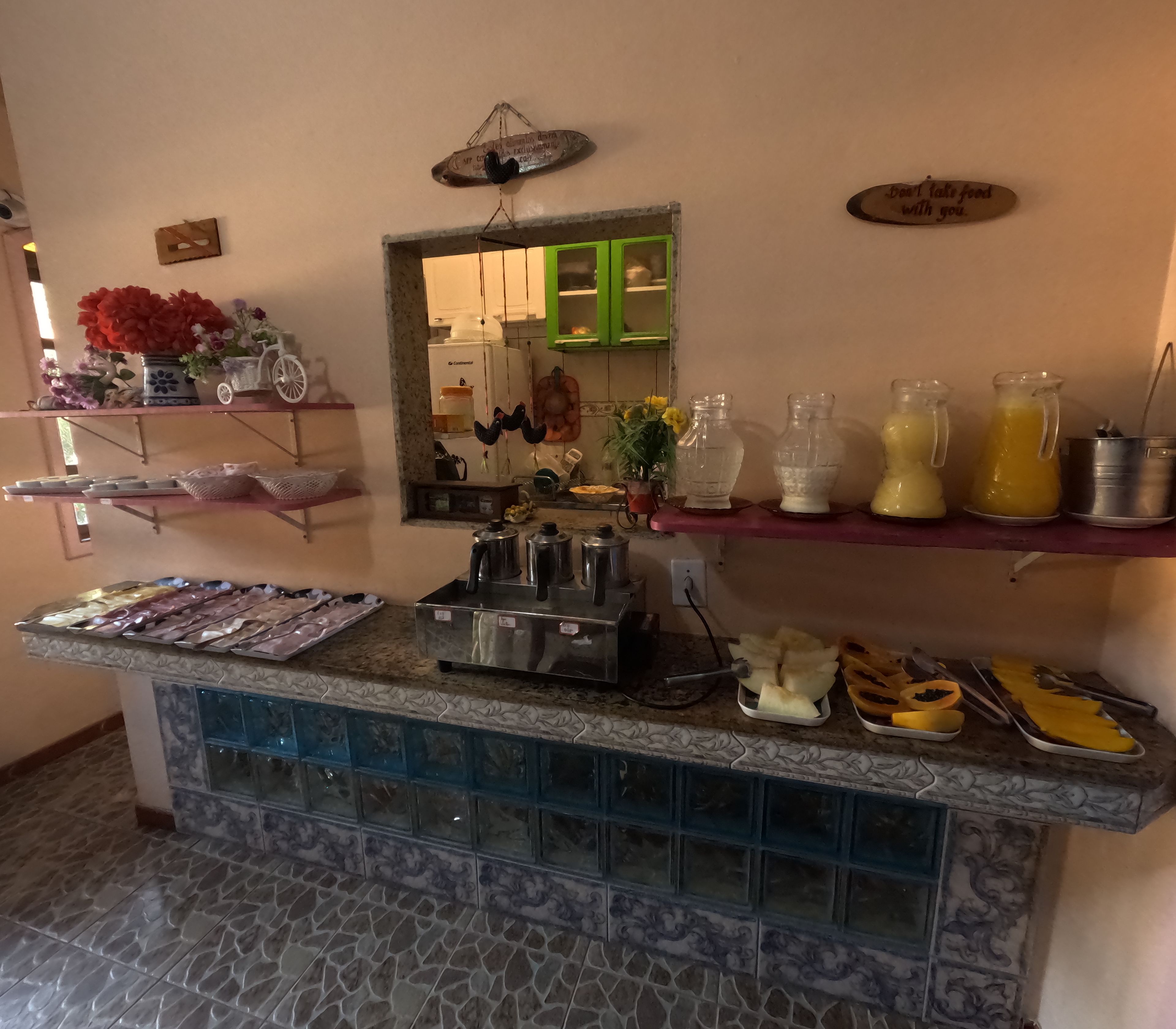 A buffet setup with various food items and a coffee machine.