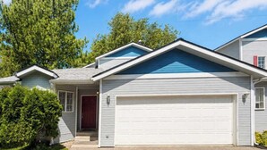 A residential house with a garage, a front door, and a small porch. - Unwind at Midtown Haven (Coeur d'Alene)