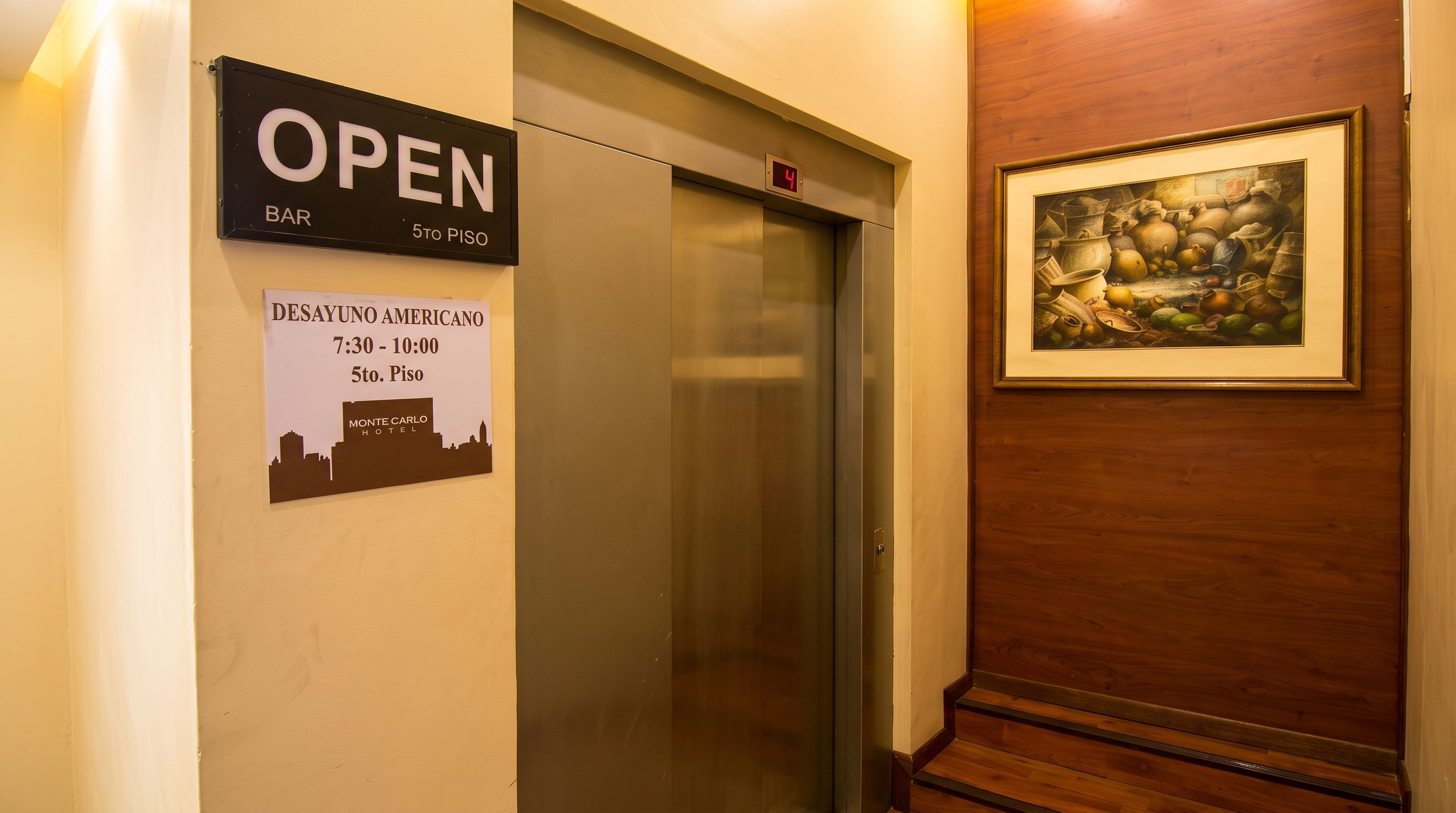 An elevator with a sign indicating it's open and a destination sign for the 5th floor.