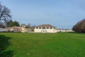 A large, historic building with a central courtyard, surrounded by a well-maintained lawn. - "Le Bellem" – Rochefort, near the town center (Rochefort)