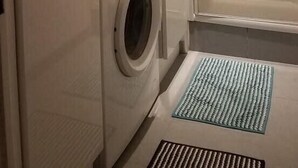 A compact bathroom with a washing machine, a sink with a large bowl, and a shower area. - "L'Hermione," Rochefort, close to the town center (Rochefort)