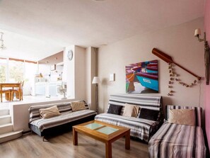 A living room with a sofa, a coffee table, and a painting on the wall. - "L'Hermione," Rochefort, close to the town center (Rochefort)