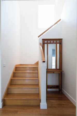 A wooden staircase with a white handrail and a small wooden bench at the top. - Sea Quinn Escape Steps to Dromana Beach and Dining (Dromana)