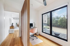 A modern interior with a large window, a desk, and a chair. - Pavilion Verde Designer Retreat near Rosebud Beach (Rosebud)