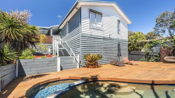 A two-story house with a deck, a small pool, and a staircase leading to the upper floor. - Foreshore Haven Poolside Comfort near Rye Beach (Rye)
