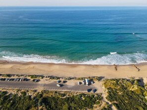 An aerial view of a beach with a parking lot and a building. - The Shack Your Ultimate Family Escape by the Sea (Rye)