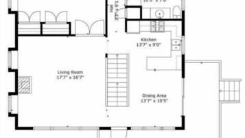 Ein Grundriss mit Schlafzimmer, Wohnzimmer, Küche, Essbereich, zwei Bädern und einer Veranda.