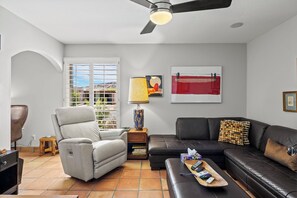 A living room with a sofa, a recliner, a coffee table, a lamp, and a ceiling fan. - Chef/Entertainer/Naturists Dream-Close to all major sports/entertainment venues! (Phoenix)