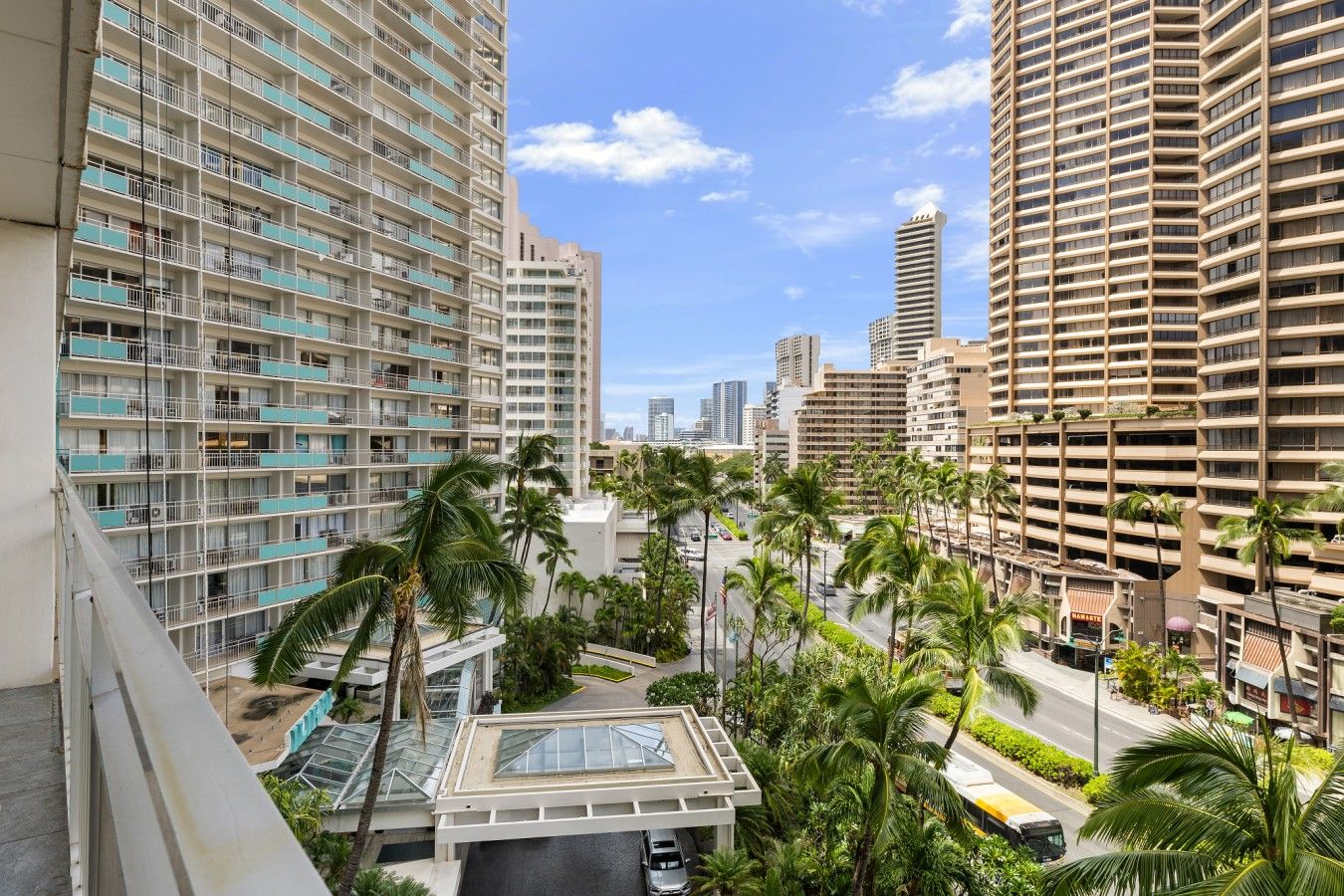 A high-rise building with multiple balconies and a clear sky.