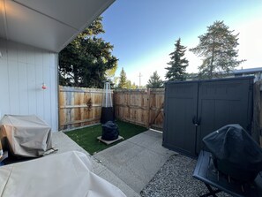 A backyard with a wooden fence, a barbecue grill, a covered table, and a shed. - Townhome with Mount Massive, Massive View! (Leadville)
