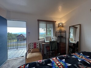 A room with a bed, a desk with a computer, a chair, a standing fan, and a window with blinds. - Townhome with Mount Massive, Massive View! (Leadville)
