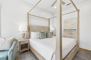 A four-poster bed with a headboard, bedside lamps, and a painting of a beach scene. - Close to Beach | Private Pool | Games | LSV (Santa Rosa Beach)
