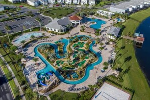 An aerial view of a resort with multiple swimming pools, a golf course, and a beachfront. - Lake View 3BR/2BA • Themed Rooms SL31418 (Kissimmee)