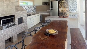 A modern kitchen with a central island, built-in appliances, and a wooden ceiling. - Mansion in Maracaipe, 100 meters from the sea, Jacuzzi, Swimming pool, Games room. (Ipojuca)