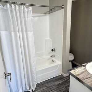 A bathroom with a shower, a bathtub, and a toilet. - Modern & Stylish Tempe 1BR | Resort Amenities (Tempe)