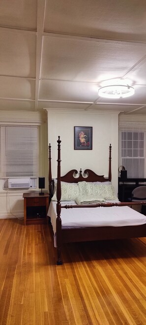 A bedroom with a wooden four-poster bed, a bedside table, a wall-mounted picture, and a window with blinds. - 2nd FL 3 Bedroom Suite, Guest Entry, Full Kitchen, Full Bath, No Dinning Room (Waltham)